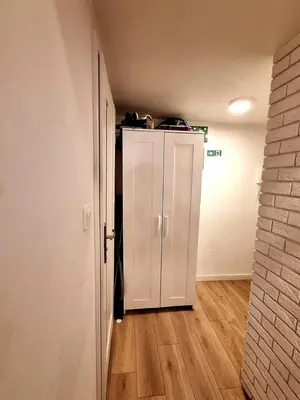 a hallway with a white cabinet in a room at Cracow Vistula Boulevard #1 - Old Town in Kraków