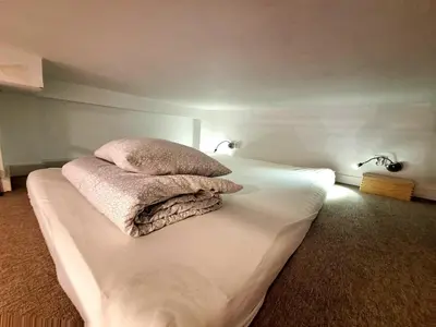 a bed with two pillows on top of it at Cracow Vistula Boulevard #1 - Old Town in Kraków