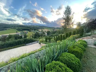a garden with green plants and a river at Słoneczne Wzgórze- Odpoczywaj Pośród Natury in Łącko