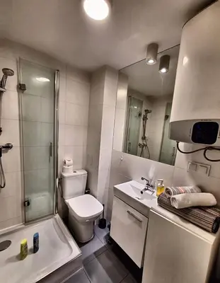 a bathroom with a toilet and a shower and a sink at Cracow Vistula Boulevard #2 - Old Town in Kraków