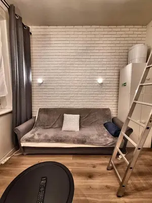a bed in a room with a brick wall at Cracow Vistula Boulevard #2 - Old Town in Kraków