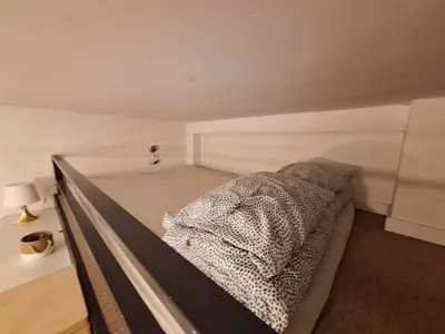 a bed in a small room with at Cracow Vistula Boulevard #3 - Old Town in Kraków