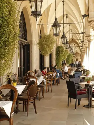 a restaurant with tables and chairs and people sitting at tables at Cracow Vistula Boulevard #3 - Old Town in Kraków