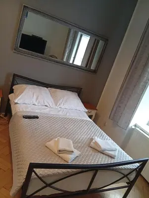 a bedroom with a bed with a mirror on the wall at Pod Topola in Kraków