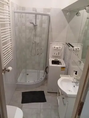 a bathroom with a shower and a sink at Pod Topola in Kraków