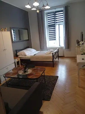 a living room with a bed and a coffee table at Pod Topola in Kraków