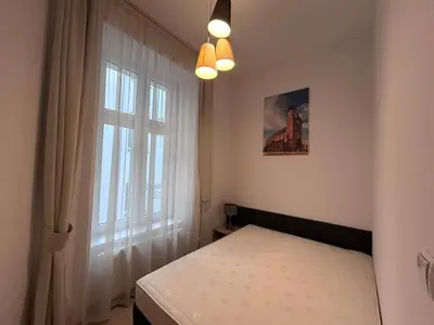a small bedroom with a bed and a window at Old Town Apt Bosacka Str - B10 in Kraków