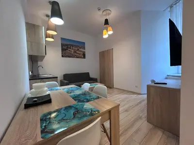 a dining room and kitchen with a table and chairs at Old Town Apt Bosacka Str - B10 in Kraków