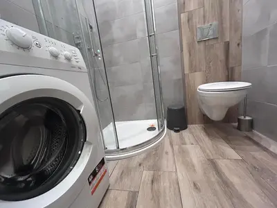 a bathroom with a washing machine and a toilet at Old Town Apt Bosacka Str - B10 in Kraków