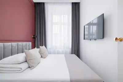 a bedroom with a bed with white sheets and pillows at AC - Sauna - 3 Bedroom Ap - Starowiślna 29 in Kraków