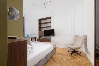 a bedroom with a bed and a chair and a desk at AC - Sauna - 3 Bedroom Ap - Starowiślna 29 in Kraków