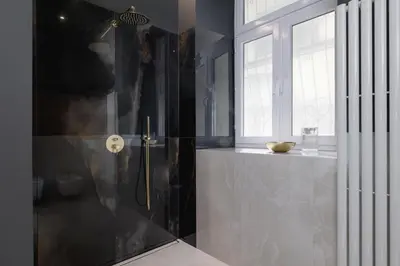 a bathroom with a shower with a glass door at AC - Sauna - 3 Bedroom Ap - Starowiślna 29 in Kraków