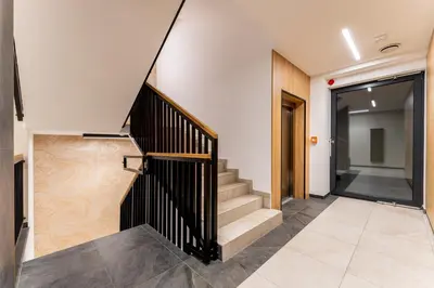a staircase in a building with a stair case at Malila Premium Apartments Cracow Plac Bohaterów Getta in Kraków