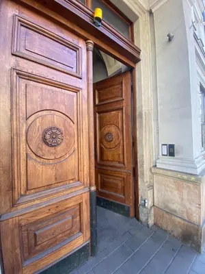 a large wooden door in a building at Hostel Uno-No Alkohol! Only Comfort Age Limit 18 until 55! in Kraków