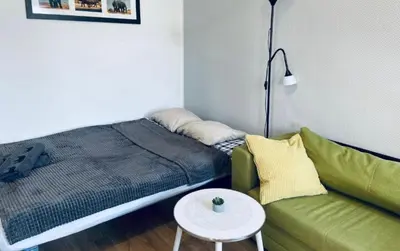 a bedroom with a bed and a couch and a table at Sołtyka Apt in Kraków