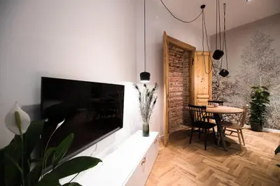 a living room with a large flat screen tv on a wall at Wawel Castle across the street! Ozonated Apartment in Kraków