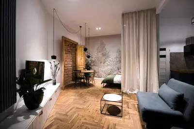a living room with a blue couch and a table at Wawel Castle across the street! Ozonated Apartment in Kraków