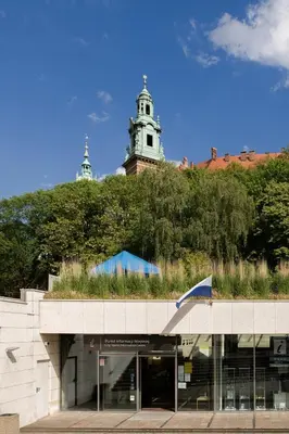 a building with a clock tower on top of a hill at Wawel Castle across the street! Ozonated Apartment in Kraków