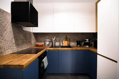 a kitchen with blue cabinets and a sink at Wawel Castle across the street! Ozonated Apartment in Kraków