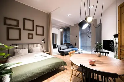 a bedroom with a bed and a dining room at Wawel Castle across the street! Ozonated Apartment in Kraków