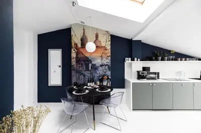 a dining room with a black table and chairs at Bright Modern Studio in the Heart of the Old Town in Kraków