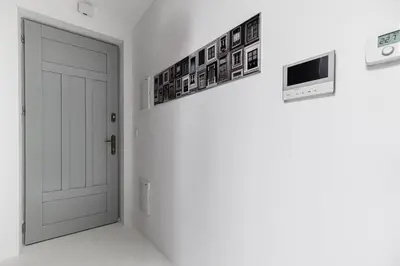 an empty room with a door and pictures on the wall at Bright Modern Studio in the Heart of the Old Town in Kraków