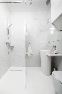 a white bathroom with a shower and a sink at Bright Modern Studio in the Heart of the Old Town in Kraków