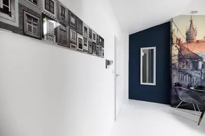 a hallway with two pictures on the wall at Bright Modern Studio in the Heart of the Old Town in Kraków