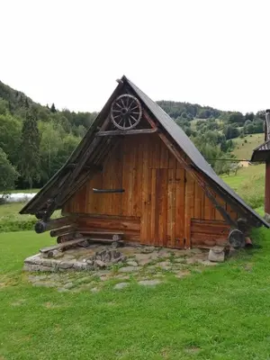 a small wooden cabin in a field of grass at Agroturystyka Anna in Ochotnica Górna