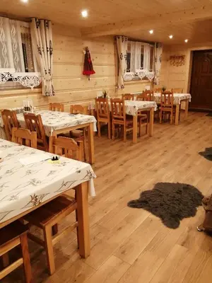 a dining room with wooden tables and chairs at Agroturystyka Anna in Ochotnica Górna