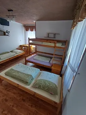 a room with three bunk beds in it at Agroturystyka Anna in Ochotnica Górna