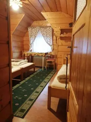 a room with three beds in a wooden cabin at Agroturystyka Anna in Ochotnica Górna
