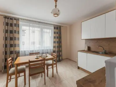 a kitchen and dining room with a table and chairs at Nocleg Wadowice in Wadowice