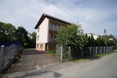 a white house with a fence in front of it at Nocleg Wadowice in Wadowice