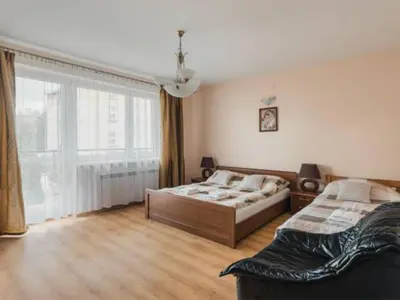 a bedroom with two beds and a large window at Nocleg Wadowice in Wadowice