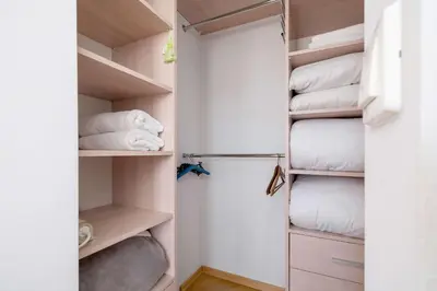 a walk in closet with towels and pillows at Przestronny i Przytulny Apartament w Krakowie z Parkingiem i Balkonem by Noclegi Renters in Kraków
