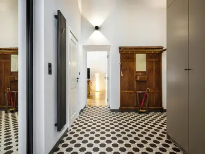 a hallway with a black and white checkered floor at Bracka by Tyzenhauz in Kraków