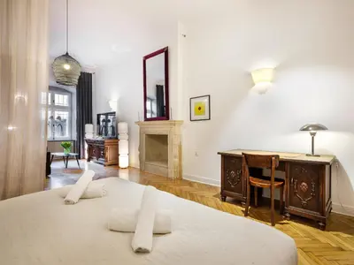 a room with a bed and a desk and a mirror at Bracka by Tyzenhauz in Kraków