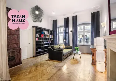 a living room with a couch and a fireplace at Bracka by Tyzenhauz in Kraków