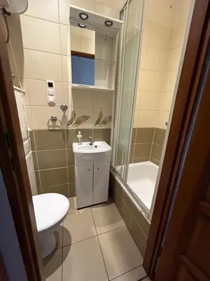 a bathroom with a toilet and a sink and a shower at Retoryka Apt in Kraków