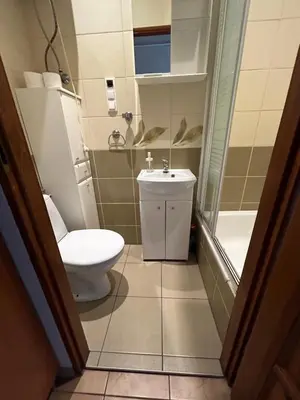 a bathroom with a toilet and a sink at Retoryka Apt in Kraków