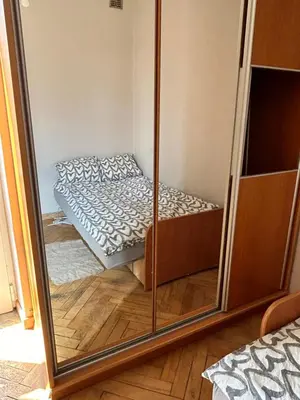 a mirror reflection of a bed in a bedroom at Retoryka Apt in Kraków