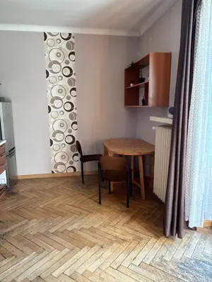 a living room with a table and a table and a dining room at Retoryka Apt in Kraków