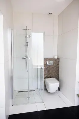 a white bathroom with a shower and a toilet at Loft House Rabka dom na wyłączność z jacuzzi SKI&SPA in Rabka