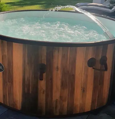 a wooden tub with a water fountain in it at Loft House Rabka dom na wyłączność z jacuzzi SKI&SPA in Rabka