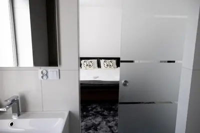 a bathroom with a sink and a bed with a mirror at Loft House Rabka dom na wyłączność z jacuzzi SKI&SPA in Rabka