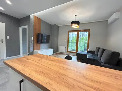 a living room with a table and a couch at ApartmentPrestige Premium in Kraków