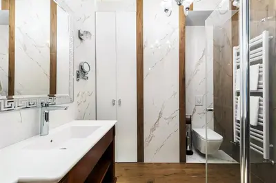 a bathroom with a sink and a toilet at ApartmentPrestige Premium in Kraków