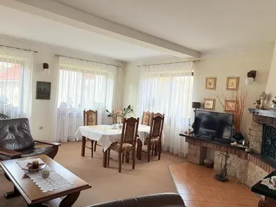 a living room with a table and a tv at Pensjonat Rezydencja Zuzanna Bed&Breakfast Sucha Beskidzka in Sucha Beskidzka