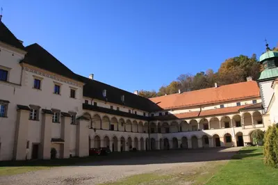 a large building with a tower on top of it at Pensjonat Rezydencja Zuzanna Bed&Breakfast Sucha Beskidzka in Sucha Beskidzka